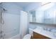 Bathroom features a shower and tub, a modern vanity, updated fixtures, and soothing blue walls at 8819 Dunes Ct # 208, Kissimmee, FL 34747