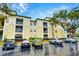 View of the property complex with ample parking and landscaping at 8819 Dunes Ct # 208, Kissimmee, FL 34747