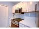 Close-up of the kitchen featuring modern appliances and ample cabinet space at 8819 Dunes Ct # 208, Kissimmee, FL 34747