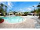 Beautiful community pool with clear water, plenty of lounge chairs, and mature landscaping at 8819 Dunes Ct # 208, Kissimmee, FL 34747