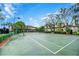 Nicely maintained tennis court with fresh lines surrounded by manicured landscaping at 8819 Dunes Ct # 208, Kissimmee, FL 34747