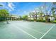 Well maintained tennis court with fresh lines surrounded by manicured landscaping at 8819 Dunes Ct # 208, Kissimmee, FL 34747