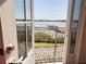 Charming balcony view overlooking a lake and dock, through an open door at 9137 Southern Breeze Dr, Orlando, FL 32836