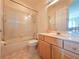 Bright bathroom featuring a glass-enclosed shower and a wooden vanity at 9137 Southern Breeze Dr, Orlando, FL 32836