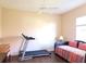 Neutral bedroom with a treadmill, daybed and ceiling fan at 9137 Southern Breeze Dr, Orlando, FL 32836