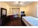 Cozy bedroom with a large bed, hardwood floors, and a dresser at 9137 Southern Breeze Dr, Orlando, FL 32836