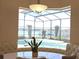 Bright breakfast nook with bench seating overlooks the pool and dock at 9137 Southern Breeze Dr, Orlando, FL 32836