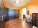 Spacious closet featuring hardwood floors, custom storage and orange walls at 9137 Southern Breeze Dr, Orlando, FL 32836