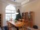 Elegant dining room featuring a large window, chandelier, and display cabinet at 9137 Southern Breeze Dr, Orlando, FL 32836