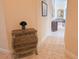 Inviting hallway featuring tile floors, wall decor, and a wooden accent table for added charm at 9137 Southern Breeze Dr, Orlando, FL 32836