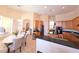 Open kitchen with wood cabinets and black countertops, plus an adjacent breakfast nook and access to the living area at 9137 Southern Breeze Dr, Orlando, FL 32836