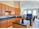 Spacious kitchen with black countertops, an island and adjacent living area at 9137 Southern Breeze Dr, Orlando, FL 32836