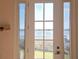 Scenic lake view seen through a window with a white frame and a metal balcony at 9137 Southern Breeze Dr, Orlando, FL 32836