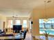 Open-concept living room with large windows overlooks the pool and canal at 9137 Southern Breeze Dr, Orlando, FL 32836