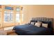 Bright main bedroom featuring large windows offering views of the water at 9137 Southern Breeze Dr, Orlando, FL 32836