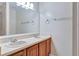 Bathroom with double sinks, granite counters, and tiled shower at 975 Cross Cut Way, Longwood, FL 32750