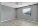 Bedroom featuring wood-look floors, ceiling fan and a single window at 975 Cross Cut Way, Longwood, FL 32750