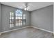 Bedroom with large windows and modern gray walls, providing ample natural light at 975 Cross Cut Way, Longwood, FL 32750