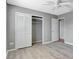 Bedroom featuring wood-look floors, ceiling fan and a closet at 975 Cross Cut Way, Longwood, FL 32750