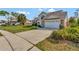 Spacious two-car garage and large driveway leading up to the charming two-story home at 975 Cross Cut Way, Longwood, FL 32750