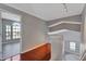 Hallway with wood floors, white railings and view into another room at 975 Cross Cut Way, Longwood, FL 32750