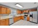 Traditional-style kitchen with stainless steel appliances and wood cabinetry at 975 Cross Cut Way, Longwood, FL 32750