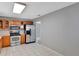 Traditional kitchen featuring stainless steel appliances, wood cabinets, and tile flooring at 975 Cross Cut Way, Longwood, FL 32750