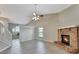 Spacious living room with brick fireplace and gray vinyl flooring at 975 Cross Cut Way, Longwood, FL 32750