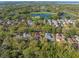 Aerial view of a residential community with a golf course, water, and picturesque landscaping at 9783 Covent Garden Dr, Orlando, FL 32827