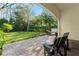 Relaxing backyard features a covered patio, hammock, and neatly manicured lawn at 9783 Covent Garden Dr, Orlando, FL 32827