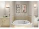 Elegant bathroom featuring a soaking tub, decorative tile accents, and and vanities at 9783 Covent Garden Dr, Orlando, FL 32827