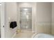 Bright bathroom offering frameless glass shower and tiled walls adjacent to the relaxing soaking tub at 9783 Covent Garden Dr, Orlando, FL 32827