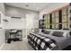 Bedroom featuring cool gray tones, contemporary decor, and a modern bed with a patterned blanket at 9783 Covent Garden Dr, Orlando, FL 32827