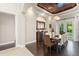 Dining room with wood floors, coffered ceiling, chandelier, and French doors at 9783 Covent Garden Dr, Orlando, FL 32827