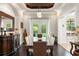 Formal dining room with coffered ceiling, elegant chandelier, and ample seating at 9783 Covent Garden Dr, Orlando, FL 32827