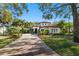 Stunning single-Gathering home boasts lush landscaping, a red tile roof, and a brick-paved driveway at 9783 Covent Garden Dr, Orlando, FL 32827