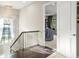 Hallway with railing and chandelier leads to an office space at 9783 Covent Garden Dr, Orlando, FL 32827