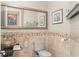 Chic powder room features decorative tile accent wall, modern vessel sink, and elegant mirror at 9783 Covent Garden Dr, Orlando, FL 32827