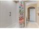 Bathroom shower and tub with tiled walls, grab bar and decorative shower curtain at 10303 Atwater Bay Dr, Winter Garden, FL 34787