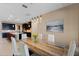 Dining area with dark wood cabinets, marble table, modern lighting, and an open floor plan concept at 10303 Atwater Bay Dr, Winter Garden, FL 34787