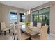 Dining room with marble table, elegant lighting, seating for six, and outdoor views of the lake at 10303 Atwater Bay Dr, Winter Garden, FL 34787