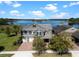 Beautiful two-story home with a two-car garage and a well-manicured lawn overlooking a serene lake at 10303 Atwater Bay Dr, Winter Garden, FL 34787