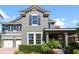 Charming two-story home with gray siding, manicured landscaping, and a brick driveway at 10303 Atwater Bay Dr, Winter Garden, FL 34787