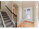 Bright foyer with decorative glass door, tile floors and staircase with wrought iron spindles at 10303 Atwater Bay Dr, Winter Garden, FL 34787