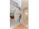 Bright foyer featuring a staircase with iron railing, tiled floors, and an open floor plan at 10303 Atwater Bay Dr, Winter Garden, FL 34787