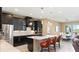 Modern kitchen featuring dark cabinets, stainless steel appliances, and a breakfast bar at 10303 Atwater Bay Dr, Winter Garden, FL 34787