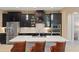 Modern kitchen featuring a large island, stainless steel appliances, and dark cabinetry at 10303 Atwater Bay Dr, Winter Garden, FL 34787