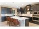 Modern kitchen with dark cabinetry, a large island, and stainless steel appliances at 10303 Atwater Bay Dr, Winter Garden, FL 34787