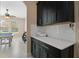 Kitchenette featuring dark cabinets, white countertops, and easy access to game room and kitchen at 10303 Atwater Bay Dr, Winter Garden, FL 34787