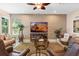 Cozy living room with ceiling fan, textured wall, stylish furniture, and entertainment center with large screen television at 10303 Atwater Bay Dr, Winter Garden, FL 34787